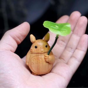 hand carved wooden Totoro figure.